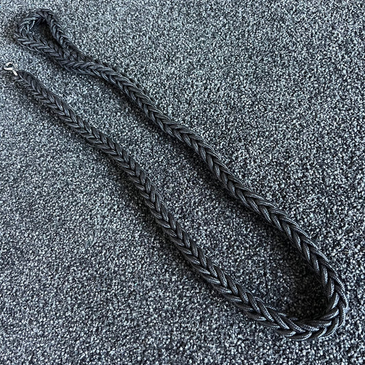 Black braided leash on a textured gray surface