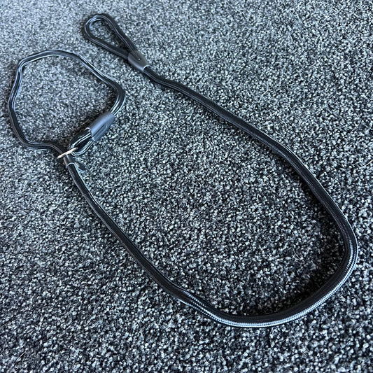Black Slip Leash on a textured gray surface