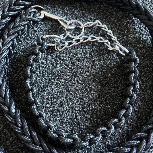 dog collar with braided design on a textured surface