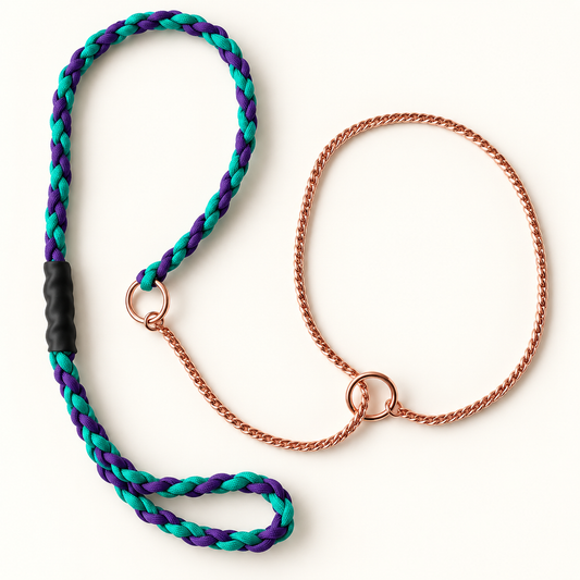 A braided dog leash with a purple and teal rope handle, a black grip, and a copper-colored metal chain with a ring, shown on a clean off-white background.